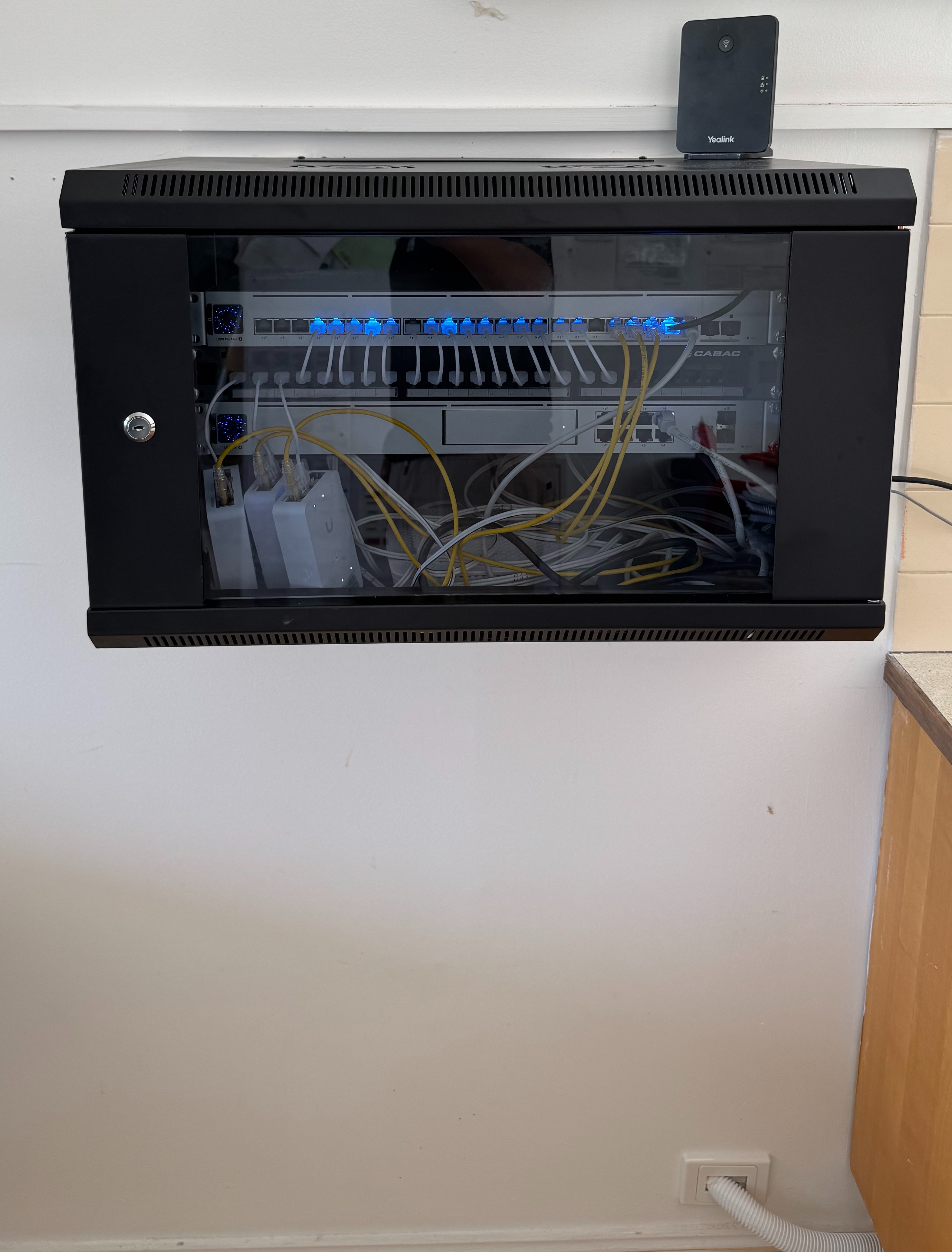Wall-mounted network rack and cabling